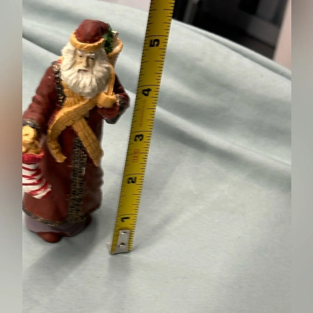 Santa collectible figure in plaster. Santa carries a stocking & basket of treats